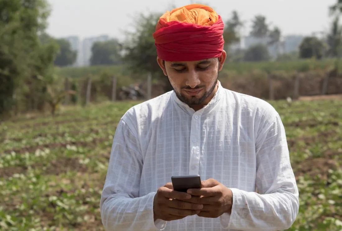 A man in a farm with mobile